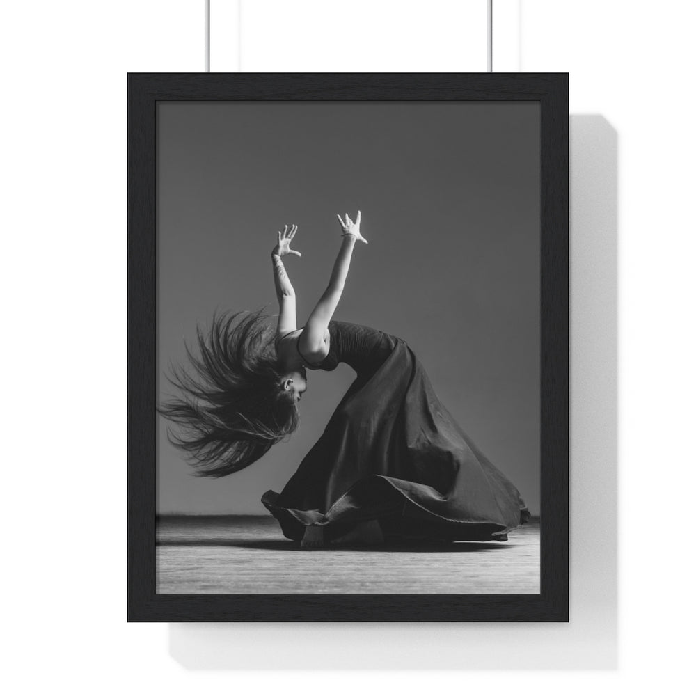 Dancer in a black dress photographed in movement dancing flamenco